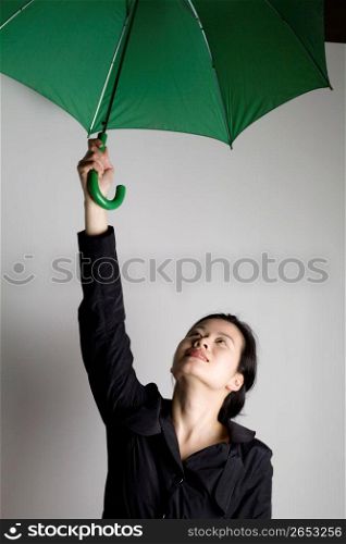 Young woman standing with umbrella