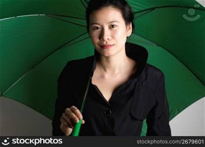 Young woman standing with umbrella, portrait