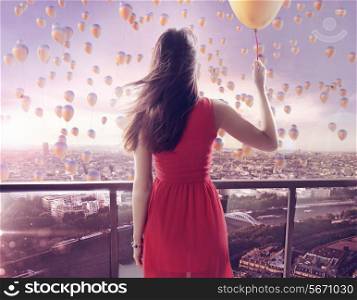 Young woman staring at thousands of the colorful balloons