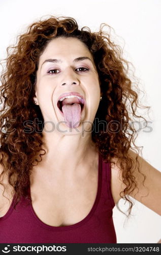 Young woman sticking out her tongue