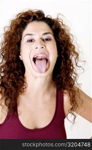 Young woman sticking out her tongue