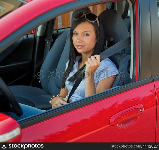 young woman strapped to the seat belt in a car