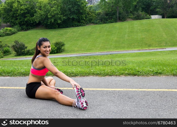 Young woman stretches before running