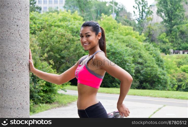 Young woman stretches before running