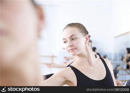 Young woman stretches into ballet pose