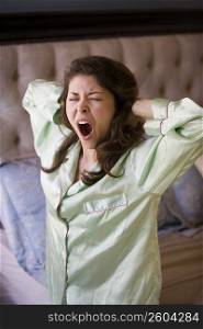 Young woman stretching and yawning