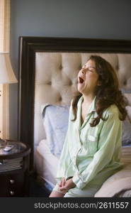 Young woman stretching and yawning