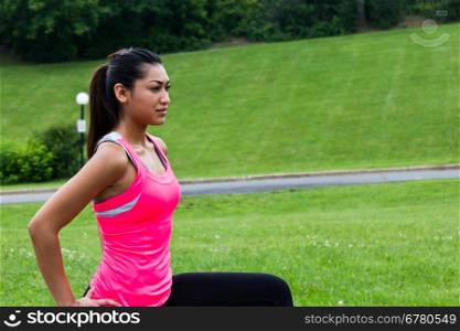 Young woman stretching before a run
