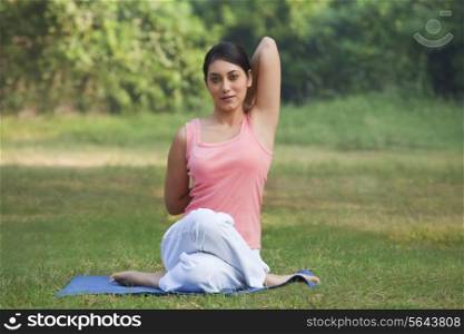 Young woman stretching her arms in a yoga