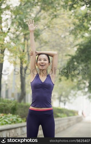 Young woman stretching in the park
