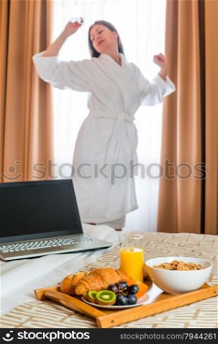 Young woman stretching near the window in the early morning