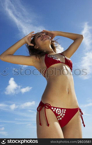 Young woman stretching on beach