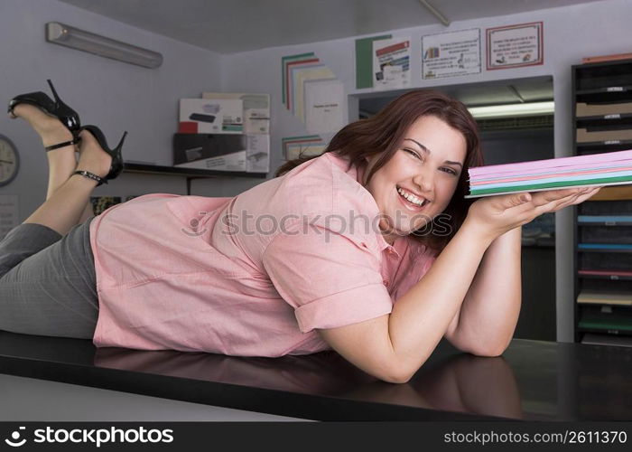Young woman striking a sexy pose at copy center