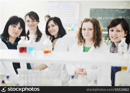 young woman students group in bright chemistry lab