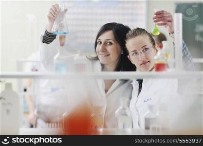 young woman students group in bright chemistry lab