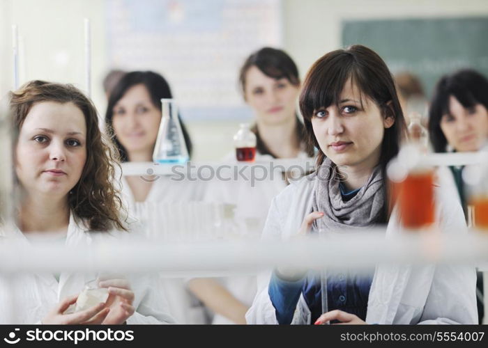 young woman students group in bright chemistry lab