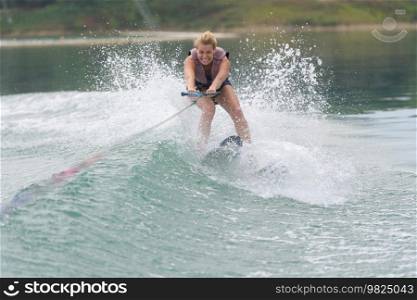 young woman study riding wakeboarding on a lake