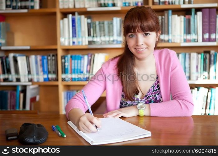 Young woman studying at the library