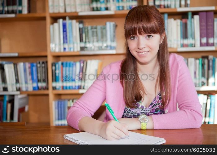 Young woman studying at the library