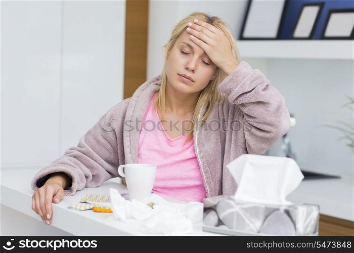 Young woman suffering from headache and cold