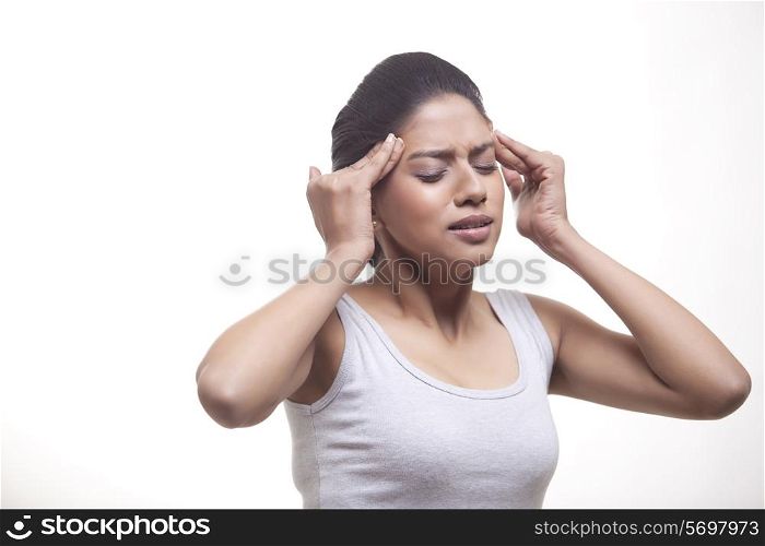 Young woman suffering from headache isolated over white background
