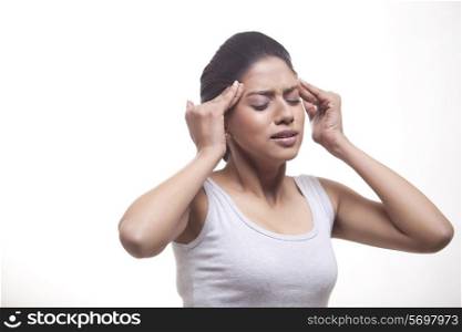 Young woman suffering from headache isolated over white background