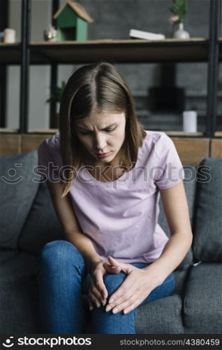 young woman suffering from knee pain