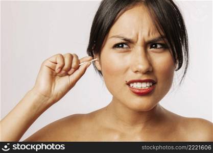 young woman suffering with cotton swabs
