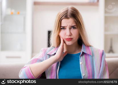 Young woman suffering with pain at home