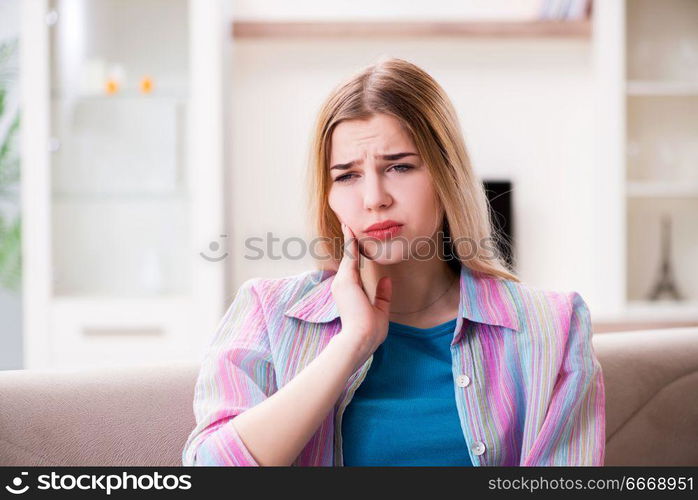 Young woman suffering with pain at home