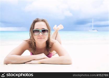 Young woman sunbathing at the tropic sea