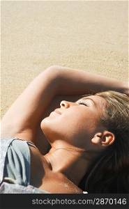 Young Woman Sunbathing on Beach