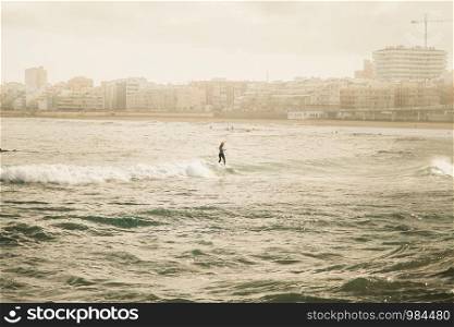 Young woman surfer dressed as Santa Claus on the beach city