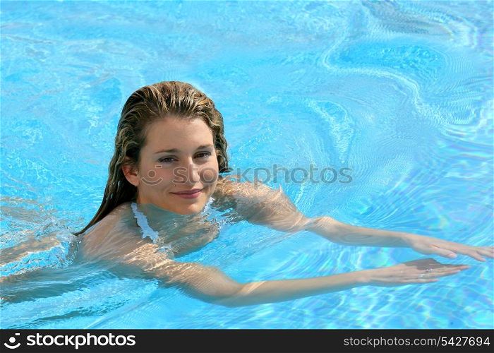 Young woman swimming in a pool