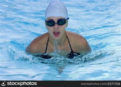 Young woman swimming in a swimming pool