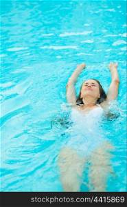 Young woman swimming in pool