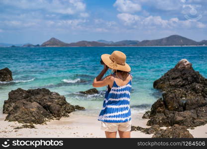 Young woman take a picture at the tropical beach, Summer vacation and travel concept