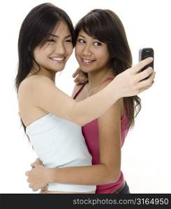 Young woman taking a picture of herself with her friend