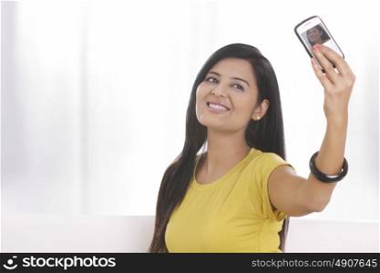 Young woman taking her own photograph