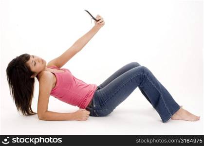 Young woman taking her photograph with a mobile phone