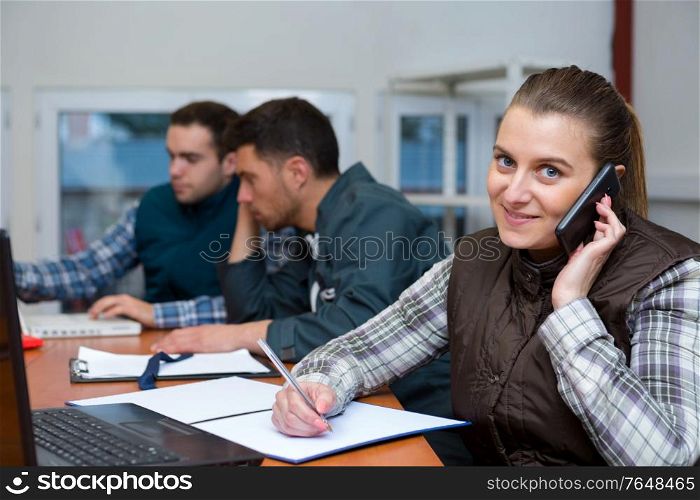 young woman taking shipment information from call