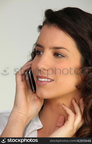 Young woman talking into a cellphone