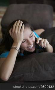 Young woman talking on a mobile phone and laughing