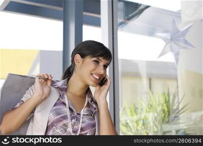 Young woman talking on a mobile phone and smiling