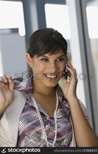 Young woman talking on a mobile phone and smiling