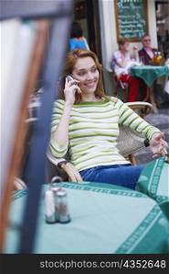 Young woman talking on a mobile phone in a restaurant