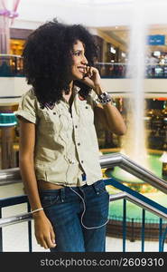 Young woman talking on cell phone in mall