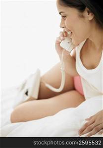 Young woman talking on the telephone and smiling