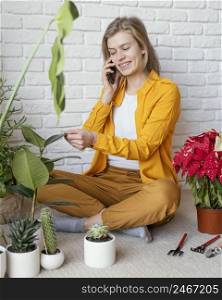 young woman talking phone her plant