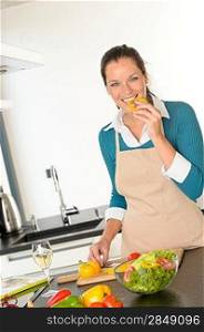 Young woman tasting preparing vegetables food dinner kitchen happy salad